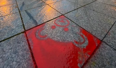Ein roter Teddy-Bärenkopf auf einem Pflasterstein in der Innenstadt.