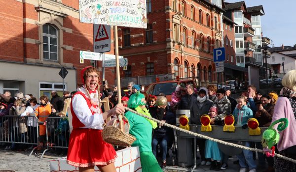Ein Mann als Rotkäppchen verkleidet.