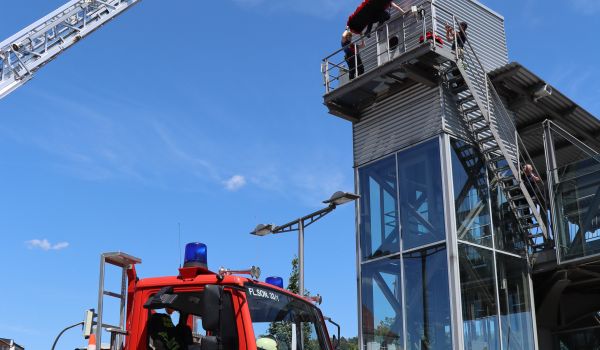 Ein Feuerwehrauto mit Drehleiter vor dem Bahnhof in Sonneberg.