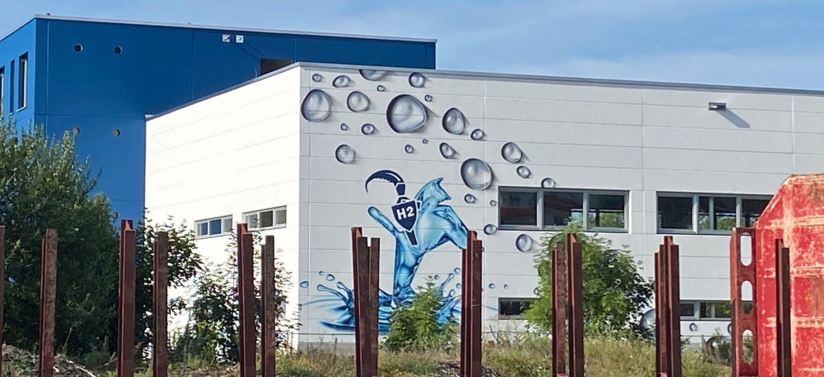 Das Wasserstoff-Institut im August 2022 von den Bahnhofsgleisen aus fotografiert.