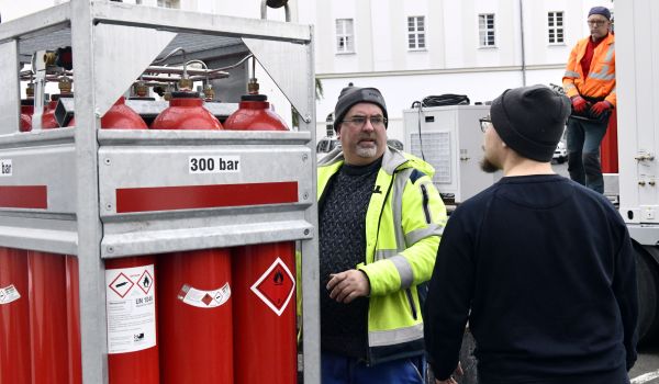 In einem Metallrahmen stehen rote Gasflaschen.